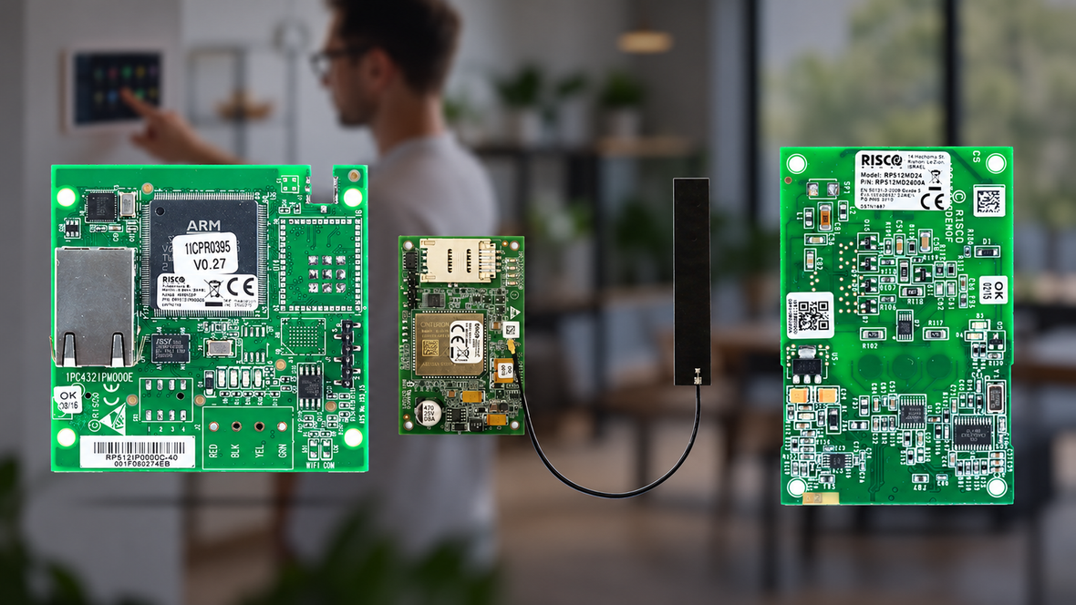 Risco IP and cellular alarm communication modules with a person using an alarm touchscreen in the blurred background.