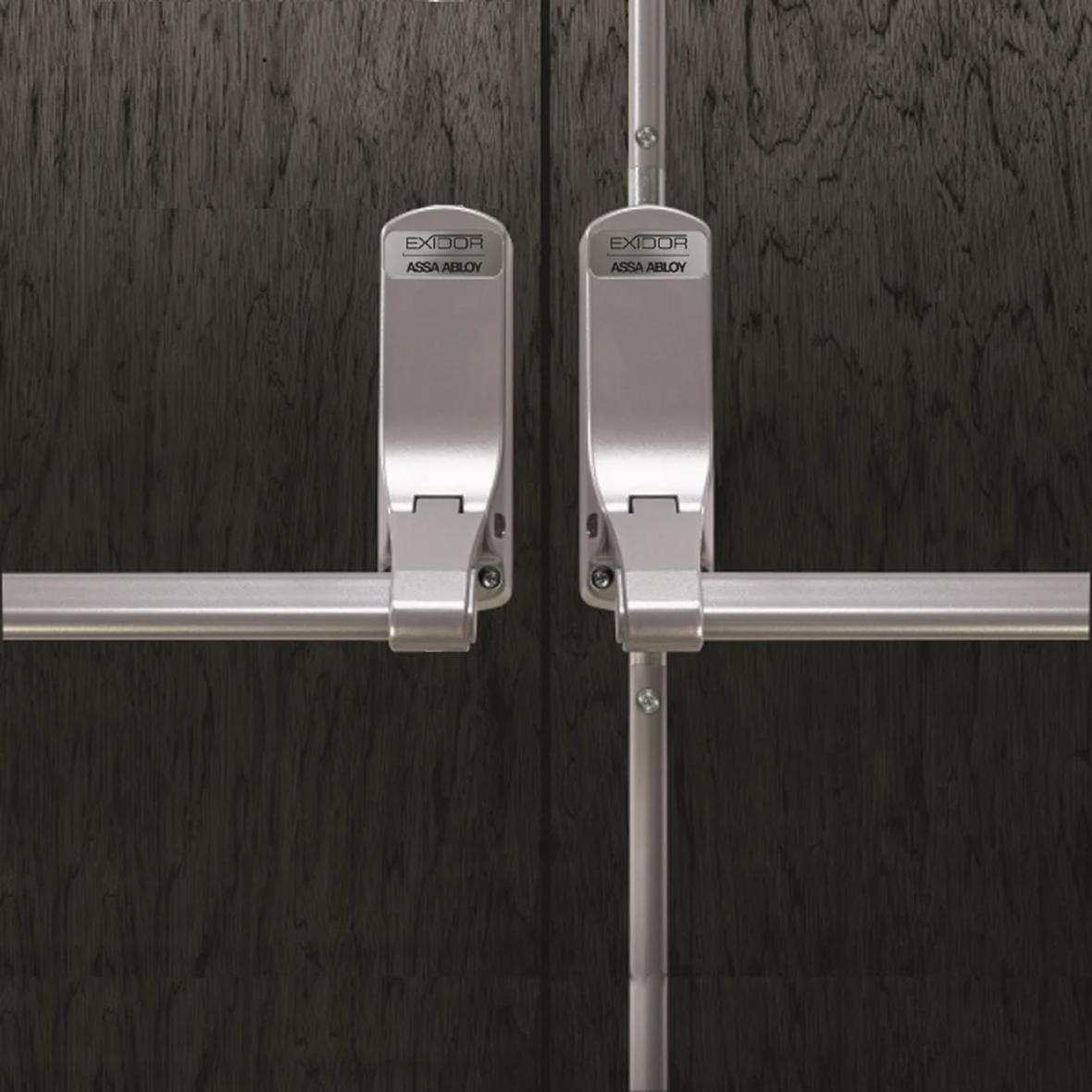 ASSA ABLOY Exidor panic bars fitted to dark timber double doors for emergency exit hardware.