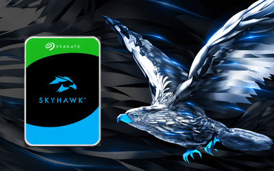 Seagate SkyHawk surveillance hard drive beside a metallic hawk graphic on a dark blue and black technology background.